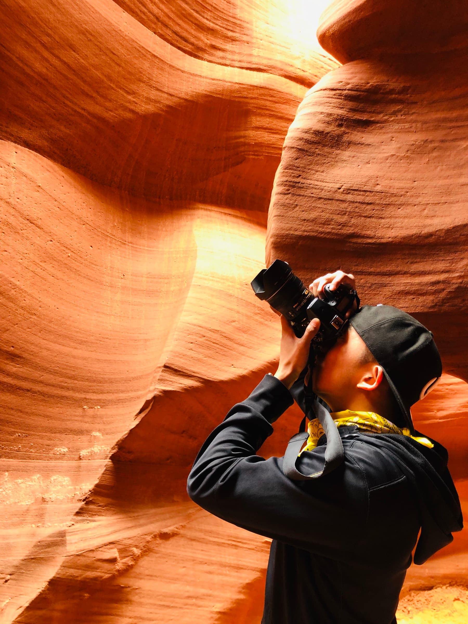 Valentino Wong photographing the sandstone walls of Antelope Canyon.